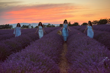 group of famales have fun in lavender flower field