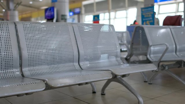 Nobody on waiting chairs zone in airport, bus station. Royalty high-quality free stock video footage of bench and chair in the terminal of airport, waiting area with chairs empty and no one or nobody