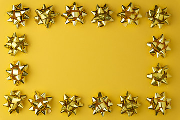 Christmas minimal pattern with gold garland shiny  on yellow pastel  background. Flat lay, top view