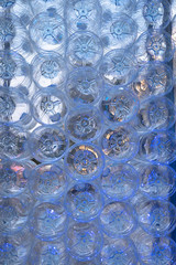 Close-up shot of stack of recyclable plastic bottles on white background.