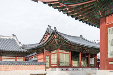 Naklejka premium Architectural detail - Korean Tradition red wooden pole and outdoor stone wall, decoration brick wall and