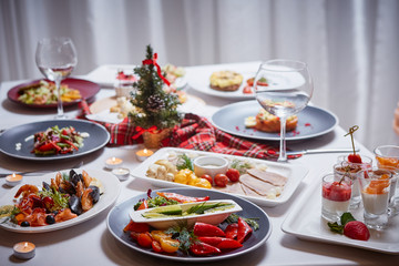 Beautifully served table with food. Festive atmosphere and decor. Celebration together