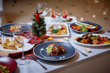 Romantic dinner setup or Holiday table setting. Many varied delicacies. Festive mood