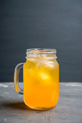 Icy cold mandarin beverage on the rustic background. Selective focus. Shallow depth of field.