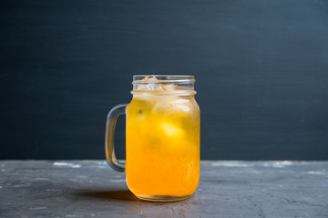 Icy cold mandarin beverage on the rustic background. Selective focus. Shallow depth of field.