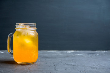 Icy cold mandarin beverage on the rustic background. Selective focus. Shallow depth of field.