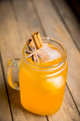 Icy cold mandarin beverage on the rustic background. Selective focus. Shallow depth of field.