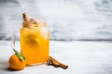Icy cold mandarin beverage on the rustic background. Selective focus. Shallow depth of field.