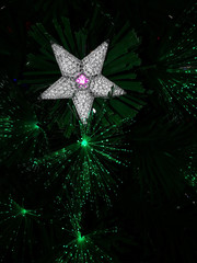 Christmas star and green light on a dark background