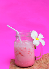 Cool pink ice milk drink for summer drinks on white backgrounds vertical side views