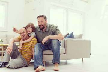Portrait of male gay couple with adopted childre
