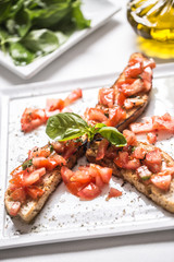 Tasty italian appetizer bruschetta on plate with olive oil