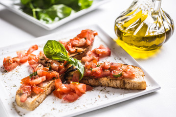 Tasty italian appetizer bruschetta on plate with olive oil