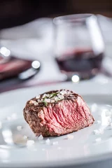 Photo sur Plexiglas Steakhouse Beef tenderloin steak on white plate and red wine in pub or restaurant