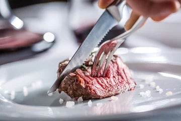 Rolgordijnen Steakhouse Beef tenderloin steak on white plate and red wine in pub or restaurant