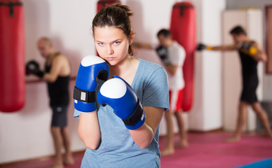 attractive sportwoman in the boxing hall practicing boxing punches