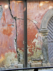 Cracked wall with old layers of paint in abandoned house in Budapest, Hungary