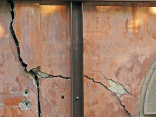 Cracked wall with old layers of paint in abandoned house in Budapest, Hungary