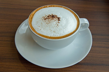 A cup of coffee in white cup.