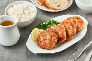 Chicken cutlets with rice on a plate for dinner