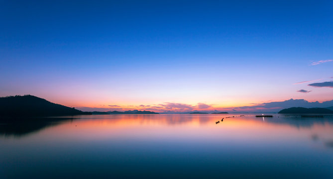 Fototapeta Colorful dramatic sky and seascape with reflection in the sea scenery of nature in evening sunset time