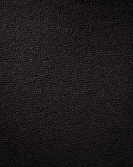 Vertical black leather texture. Synthetic material background in rough style.