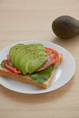 Sandwich with avocado slices and bacon