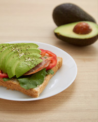 Sandwich with avocado slices and bacon