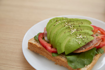 Sandwich with avocado slices and bacon