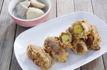 Deep fried unripe rice and grated Coconut Bananas Roll and Banana in coconut milk thai dessert