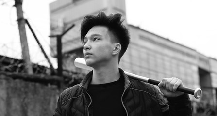 Black White photo of Asian young man outdoors posing