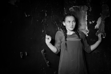 young girl portrait in an old house with burnt walls