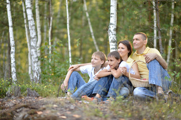 Fototapeta premium Portrait of happy family of four in autumn park