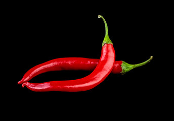 Red chilli peppers on black background