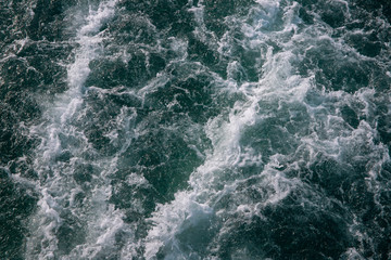 Fototapeta na wymiar Ocean water texture with white foamy wave. Tropical island hopping or marine travel banner.