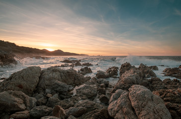 Sunset and rough sea on the coast of Corsica