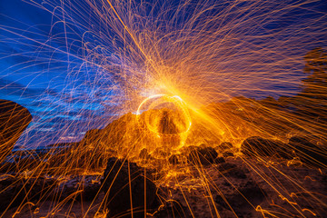 cool burning steel wool fire work photo experiments on the rock at sunrise..