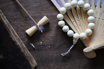 Beads and Incense on wooden table