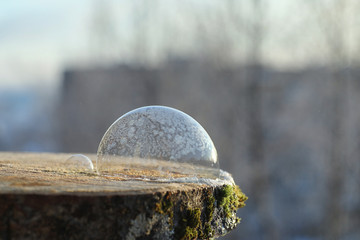 Soap bubbles freeze in the cold. Winter soapy water freezes in the air.