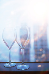 Cocktail glasses on the windowsill by the glass