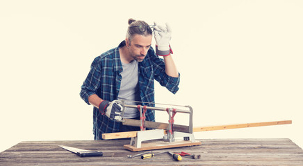 worker in blue  shirt sawing wood