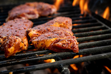 grilled pork with flames on barbecue