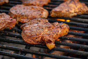 grilled pork with flames on barbecue