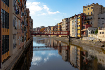 Fototapeta na wymiar Girona landmark in Catalonia. Urban scene of river facade houses and water reflection