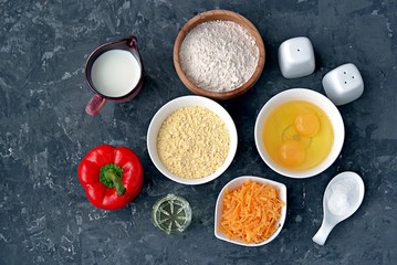 Obraz na płótnie Canvas Ingredients for cooking corn unleavened bread: wheat flour, red peppers, corn flour, oil, salt, pepper, grated cheddar cheese, baking powder, eggs, milk or buttermilk.