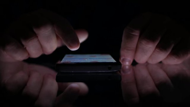 Close Up Image with Man Hands Using Smartphone Online Application in Dark 