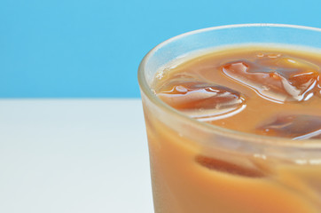 glass of cold drink on white and blue background