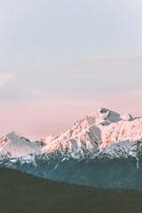 Obraz premium Snowy mountains peaks range landscape travel aerial view wilderness nature tranquil evening winter sunset scenery
