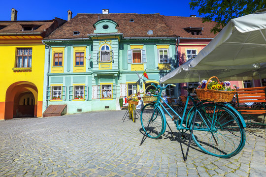 Fantastic medieval street cafe bar with traditional buildings, Sighisoara, Romania