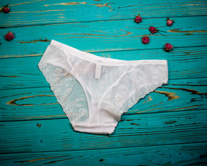 White lace panties for women on a blue background